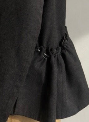 Close-up of garment structure with gathered detailing showing form and construction in the Yan Neo studio